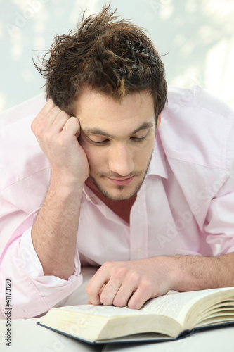 Young man reading a book
