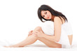 Cute woman sitting on the white bed