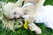 Beautiful sexy young woman outdoors, lying in the grass, relaxin