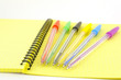 Color pens on the yellow writing-book Color pens on the yellow writing-book