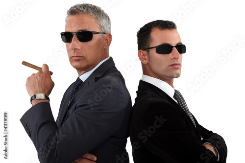 Photo: Powerful businessmen in sunglasses Powerful businessmen in sunglasses