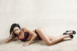 brunette in black underwear over a carpet with sensual expressio