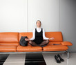 Young businesswoman meditating