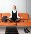 Young businesswoman meditating