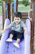 Cute baby playing on sliding board, smiling Cute baby playing on sliding board, smiling