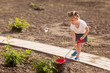 Cute Little girl gardening in summer day