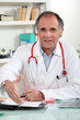 Male doctor sat in office