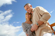Couple stood on a balcony by the sea