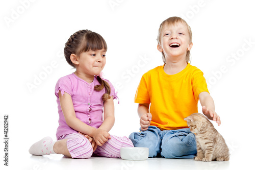 Photo: Cute children playing with kittens. Isolated on white background Cute children playing with kittens. Isolated on white background