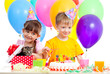 happy children celebrating birthday party with opening gift box