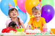 happy children celebrating birthday party with opening gift box
