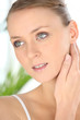 Woman touching back of neck