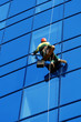 Washer wash the windows of modern skyscraper