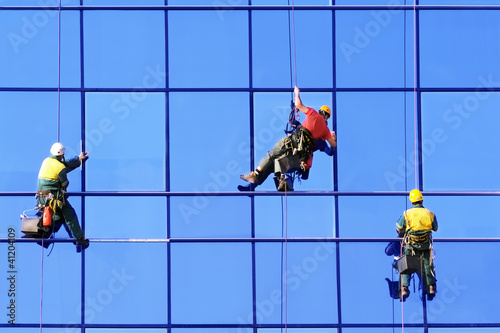 Foto: Three washers wash the windows Three washers wash the windows