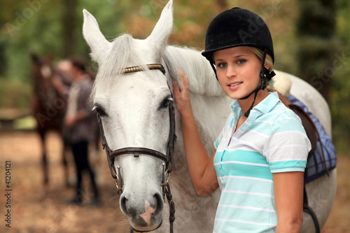 Photo: Girl stroking white horse Girl stroking white horse