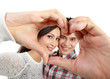 Photo: young couple in love showing heart with fingers young couple in love showing heart with fingers