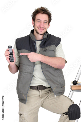 Photo: happy tiler showing mobile phone happy tiler showing mobile phone