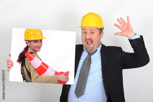 Photo: foreman holding picture of woman with construction cone foreman holding picture of woman with construction cone