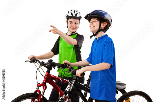 Photo: Cyckists - boy and girl isolated on white background Cyckists - boy and girl isolated on white background