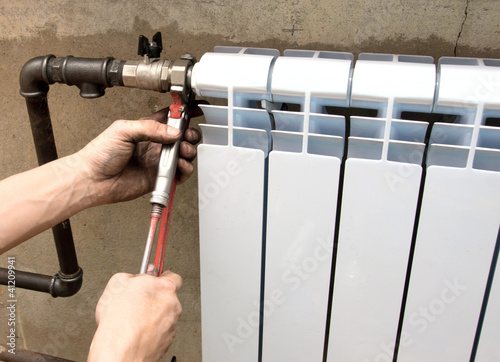 Photo: real photo of installation of a radiator real photo of installation of a radiator