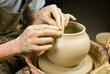 hands of a potter, creating an earthen jar of white clay hands of a potter, creating an earthen jar of white clay