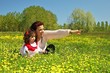 Foto: Mother showing something her daughter at the meadow Mother showing something her daughter at the meadow