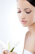 woman holding lily flower, spa theme woman holding lily flower, spa theme