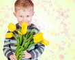 Cute little boy with yellow tulips