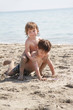 two children playing on beach two children playing on beach