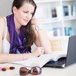 pretty female college student studying in the university library