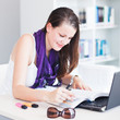 pretty female college student studying in the university library