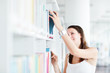 pretty female college student studying in the university library