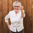 portrait of adorable senior woman doing good gesture against a w portrait of adorable senior woman doing good gesture against a w