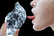 Woman licking block of ice.