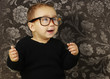 portrait of adorable kid wearing vintage glasses against a vinta portrait of adorable kid wearing vintage glasses against a vinta