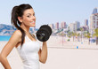 portrait of a young pretty woman holding weights and doing fitne portrait of a young pretty woman holding weights and doing fitne