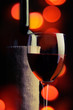 A glass and a bottle of red wine.