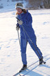girl with tense face runs on skis