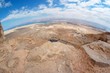 Fisheye view of desert landscape under Masada fortress