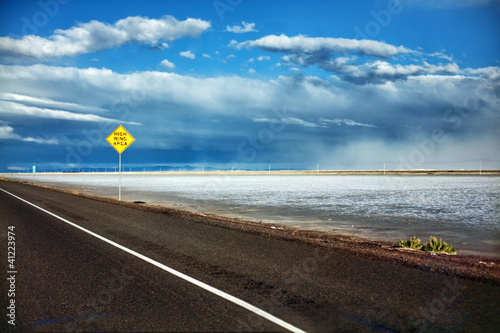 Photo: Black asphalt road through Bonneville Salt Flats in Utah sunset Black asphalt road through Bonneville Salt Flats in Utah sunset