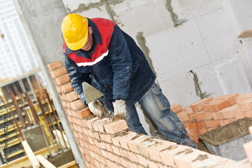 Photo: construction mason worker bricklayer construction mason worker bricklayer