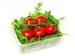 red tomatoes and green arugula, isolated on the white