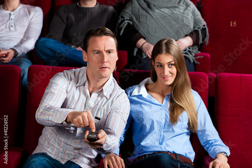 Photo: Couple and other people in cinema Couple and other people in cinema