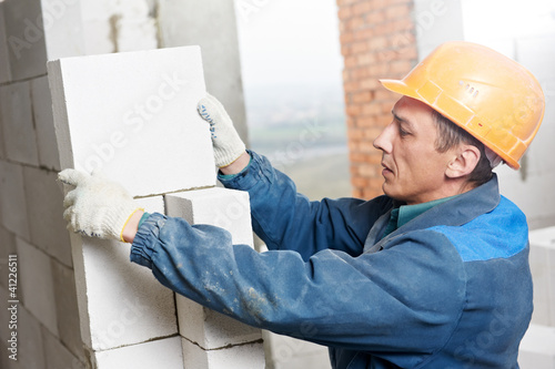 Photo: construction mason worker bricklayer construction mason worker bricklayer