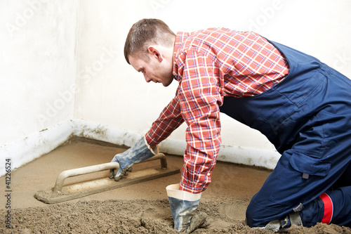 Photo: Plasterer concrete worker at floor work Plasterer concrete worker at floor work
