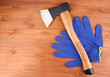 Axe and gloves on wooden background Axe and gloves on wooden background