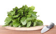 sorrel on a cutting board with knife on wooden