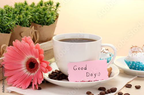 Photo: cup of coffee and gerbera beans, cinnamon sticks on wooden table cup of coffee and gerbera beans, cinnamon sticks on wooden table