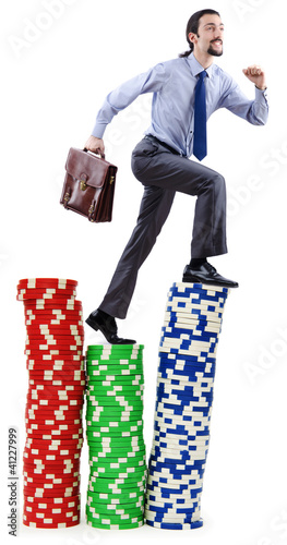 Photo: Stacks of casino chips and climbing businessman Stacks of casino chips and climbing businessman
