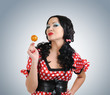 canvas print picture - Happy young woman with lollipop candy